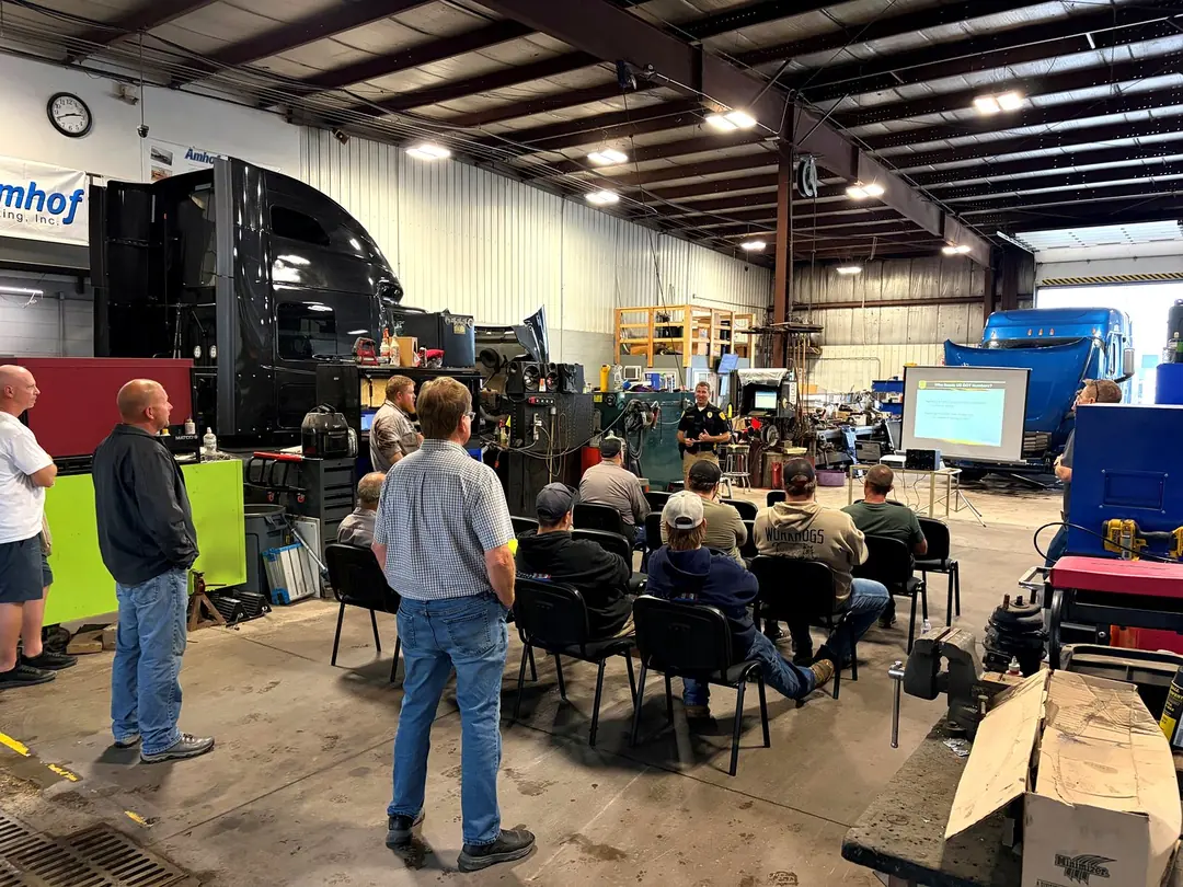 Amhof drivers and technicians at a safety training meeting in the shop